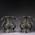 A striking pair of Chinese archaistic bronze vases. Each vase features a flared mouth and a bulbous body, decorated with...