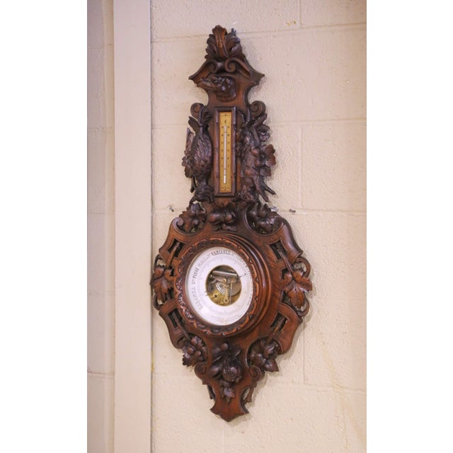 This striking antique French Black Forest–style barometer thermometer was crafted in France circa 1880 from richly carved...