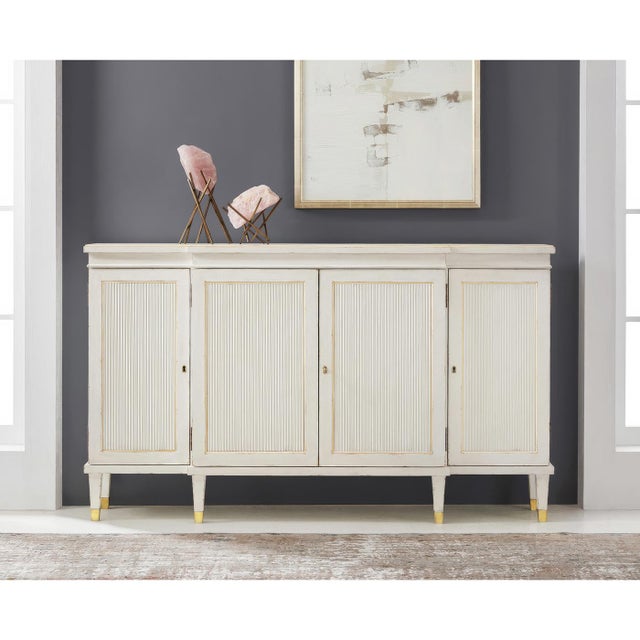 Credenza combines sophisticated style with delicate gilt accents that highlight its classical architectural details. The...