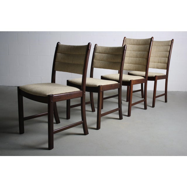Unapologetically danish modern design in afromsia wood and original upholstery. Two his chairs with corresponding Hers...