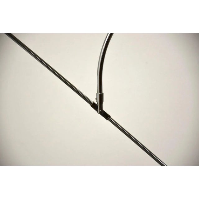 A modern chrome “Orbiter” floor lamp by Robert Sonneman with an adjustable and rotating arm. 49” wide. 14” wide. 62.75” tall.