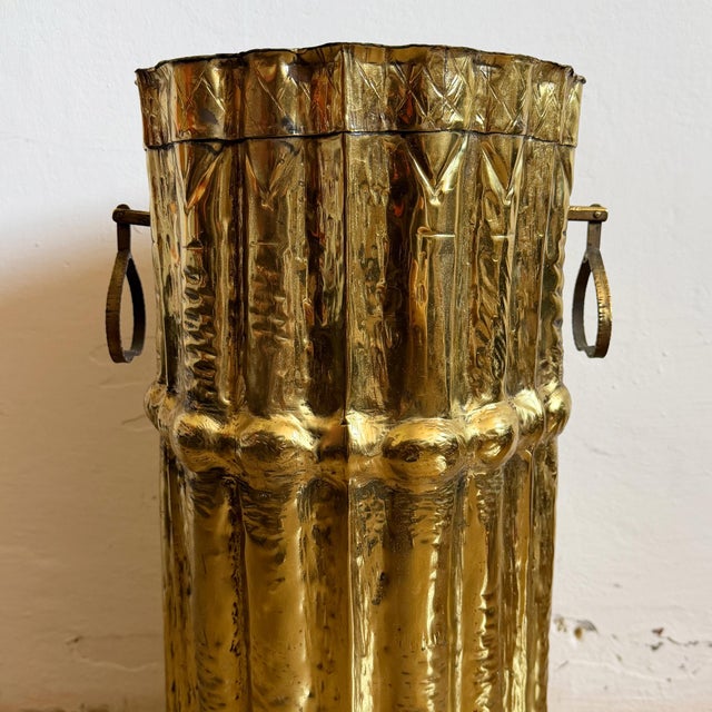 A striking vintage Italian brass umbrella stand featuring a beautifully sculptural, hand-worked design with a fluted body,...