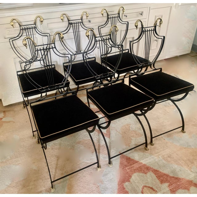 Set of six Maison Jansen folding chairs. The set are all newly powder coated black, with freshly polished brass swan and...