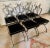Set of six Maison Jansen folding chairs. The set are all newly powder coated black, with freshly polished brass swan and...
