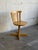 This striking swivel chair features a curved slatted backrest and smooth wooden construction. Crafted in Sweden, it...