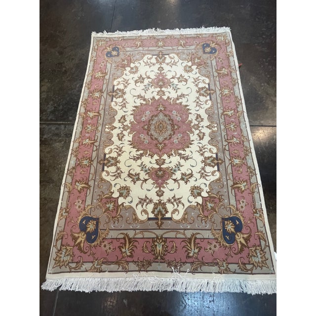 ACTUAL SIZE: 3'4" X 4'11" PRIMARY COLOR: Ivory, Pink AGE: New MATERIALS: Wool FOUNDATION: Cotton PRODUCTION: Handwoven,...