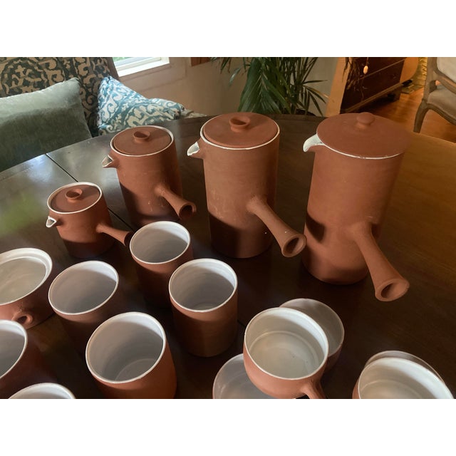 Very charming 20 piece mid-century modern terracotta tea or coffee set with matching cups and pots. This modern set...