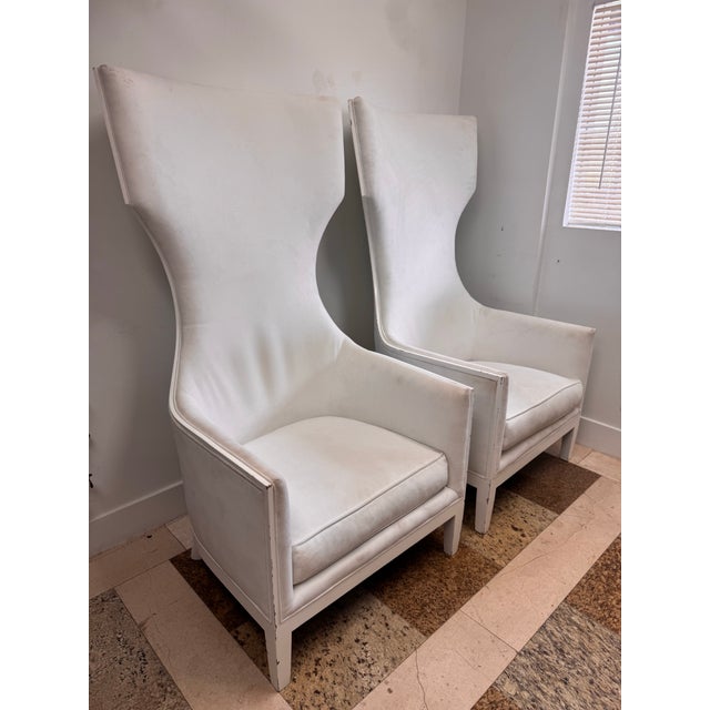 Dramatic pair of 1990s high back lounge chairs with a sculptural, flared silhouette and clean white painted frames. The...