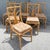 A charming set of six vintage dining chairs crafted from natural rattan with sculptural fan-shaped backs and decorative...
