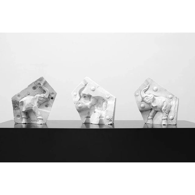 Artist molds shaped irregular pentagonal made from plaster sculptures and elephant counterpart. Figure elephant, with its...