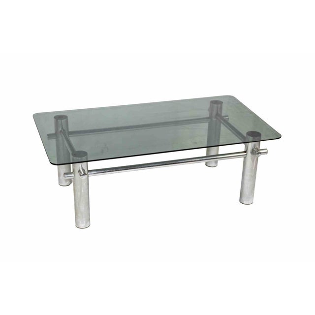 Chrome coffee table is an original design furniture realized in the mid-20th Century. A coffee table with a grey glass top...