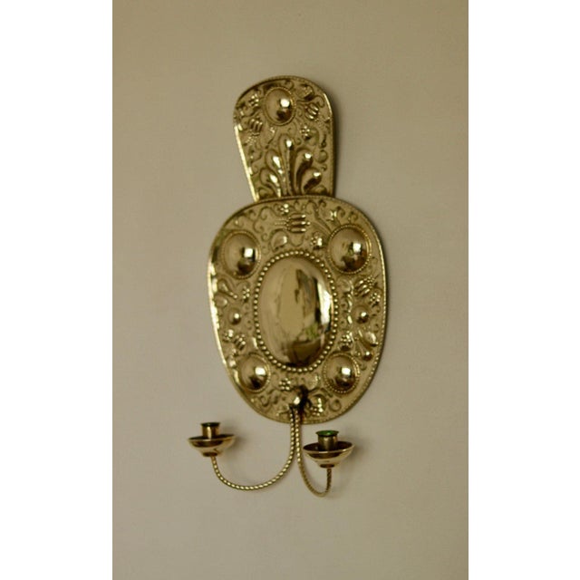 Made in Sweden A breath-taking mid-century duo of exquisite Swedish brass wall sconces, showcasing captivating hammered...