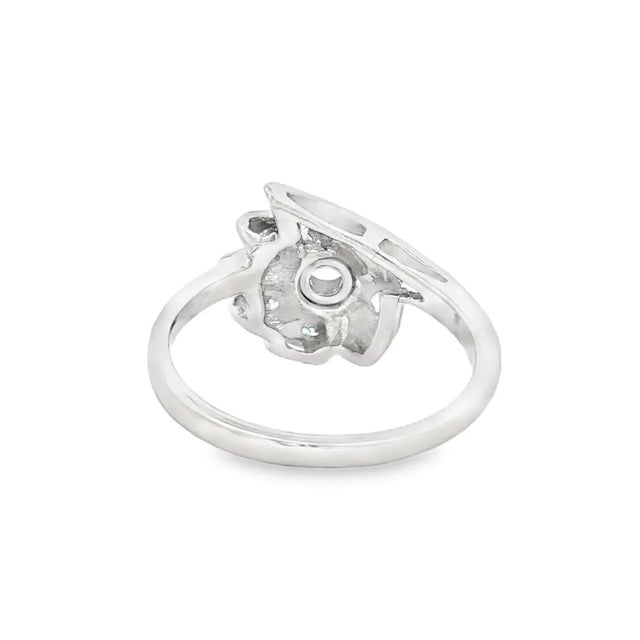 A 14k gold cocktail ring featuring a European-cut diamond. The design showcases a contemporary style with a central white...