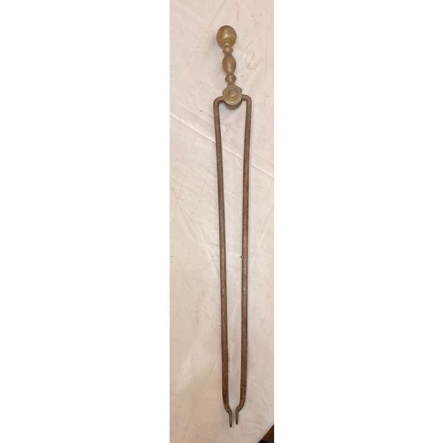 Up for sale is a pair of rare antique 18th century wrought iron and brass English fireplace tongs. The arms are wrought by...