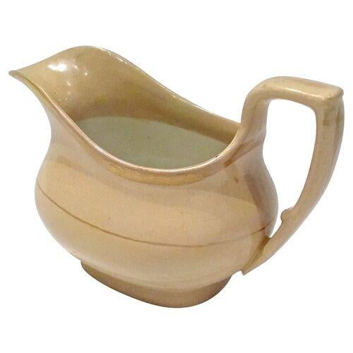 Antique English drabware creamer with spout and handle, circa 1800. Gilt accent. No maker's mark.