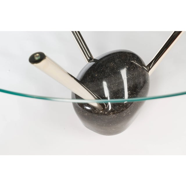 <p>This table has a Pierre Blue marble base, a circular top in bevelled glass, and 24K gold stems. It is part of...