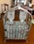 Mid-Century Modern Barware Chrome Caddy with Pressed Glass Liquor Bottles. The bottles have metal labels of ‘Scotch’ and...