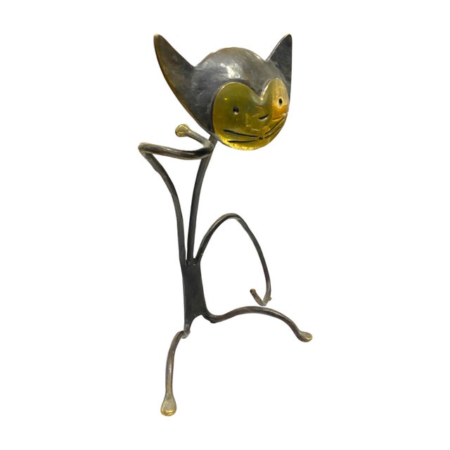 This delightful mid-century modern wine bottle holder features a stylized cat in solid brass — a whimsical and collectible...