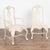 Set of ten antique Swedish dining chairs and two arm chairs in the Rococo style. Decorative carving along back, skirt and...