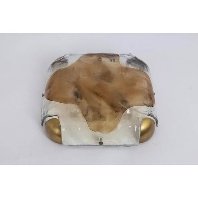 A wonderful murano glass flush mount by kaiser, germany, 1970s. Thick textured glass fixtured on a metal and brass base....