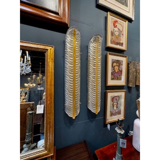 The product is a set of large scale Murano glass leaf sconces, designed in an elegant and intricate leaf-shaped form....