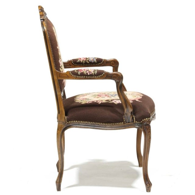 Late 20th century, carved mahogany frames with floral needlepoint upholstery and brass tack trim. 40 x 25.5 x 20 in. Good...