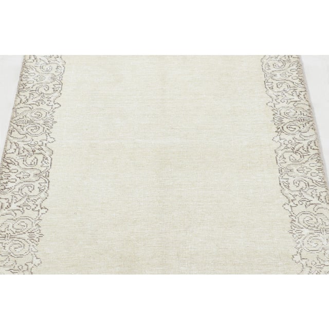Made with hand-knotted wool and originating circa 1970-1980, this 3x13 vintage Persian Tabriz runner represents a truly...