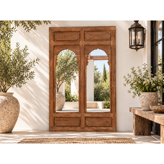 This stunning mirror is crafted from an antique architectural facade, repurposed to bring the grandeur of a Rajasthan...
