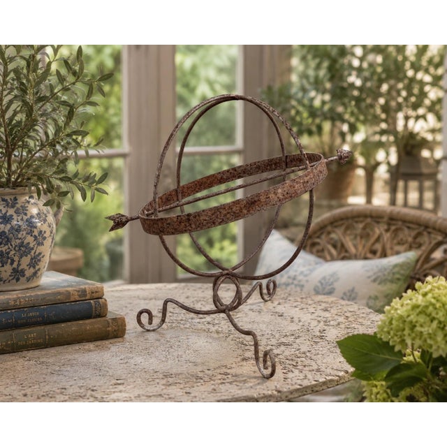 A beautifully crafted iron armillary sphere, evoking the timeless elegance of classical European gardens. Pieces like this...