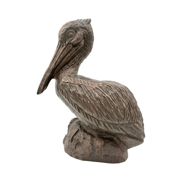 Hand-carved from a single piece of desert ironwood, this pelican has the deep, dark grain and natural luster the wood is...