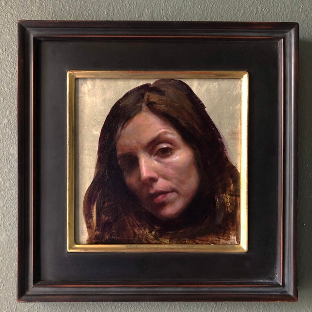 The painting features a close-up portrait of a woman's face, capturing a moment of introspection and vulnerability. The...