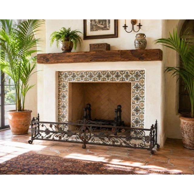 An exceptional antique Italian hand-forged wrought iron fireplace fender, dating from the late 19th century, showcasing...