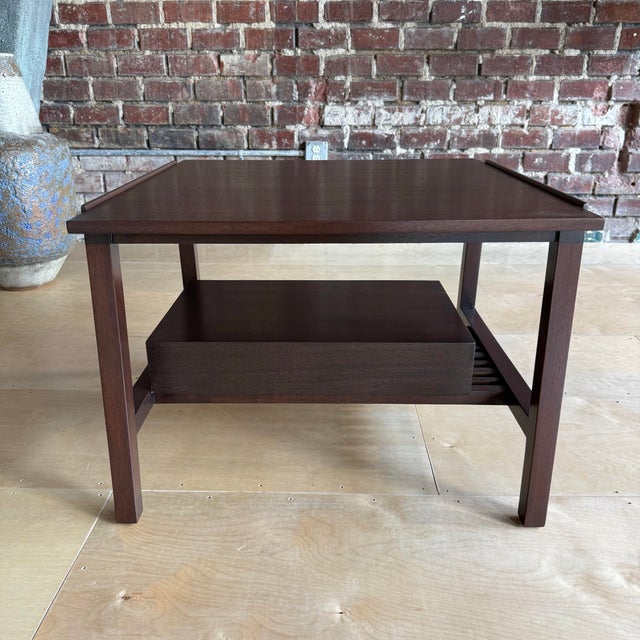 This Dunbar lamp table is a shining example of American Mid-Century excellence. The dark mahogany has been fully...