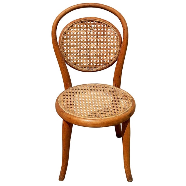 Victorian style child size Thonet number 15 oak side chair features an elegant, sculptural frame crafted from warm-toned...