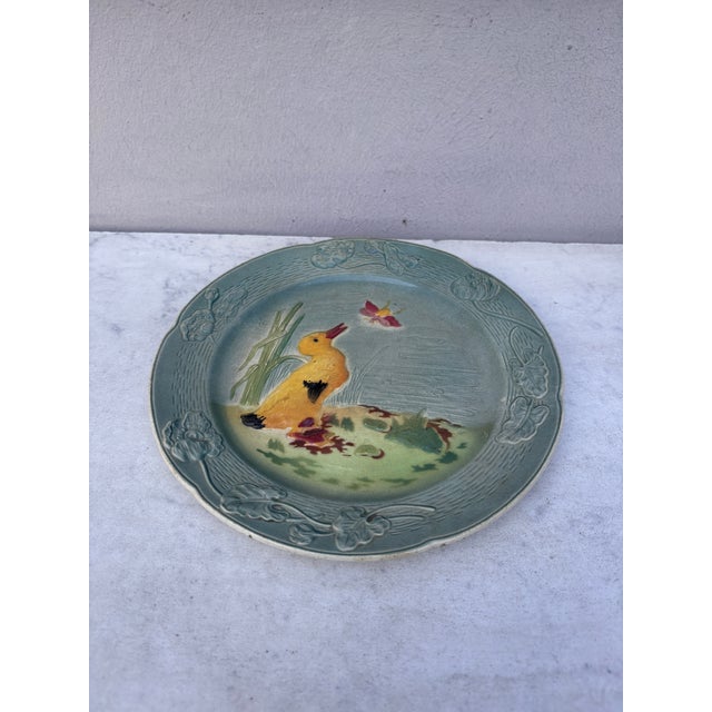 French Majolica Duckling with an insect plate Keller & Guerin Saint Clement circa 1900. Border with poppies.