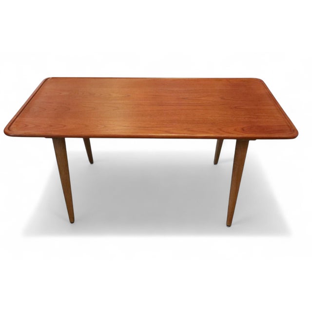 A sleek and elegant coffee table designed by hans j wegner and manufactured by andreas tuck in odense, denmark. the coffee...
