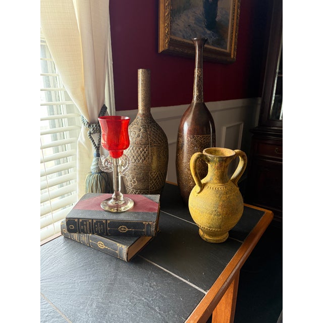 Signed and dated 1976, this Murano candlestick by Robert Levin features a rich opaque ruby cup set atop a clear sculpted...