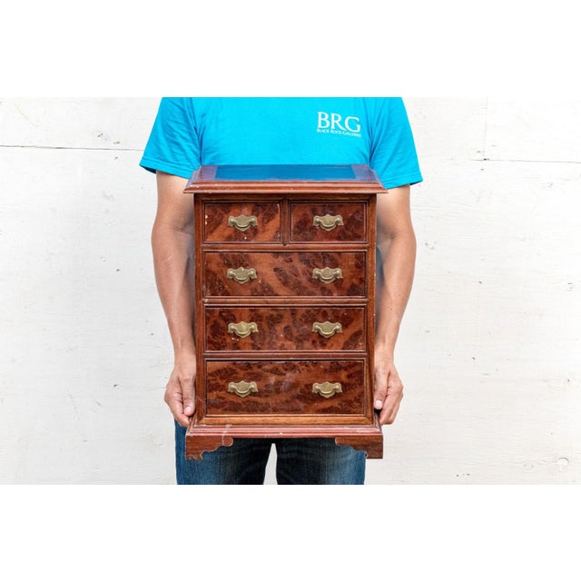 A small antique salesman sample chest of drawers in flame mahogany veneer with two short top drawers, three graduated long...