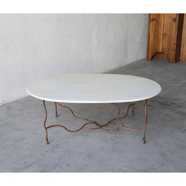 This coffee table is an elegant study in organic form and artisan craftsmanship, it features a beautiful travertine top...