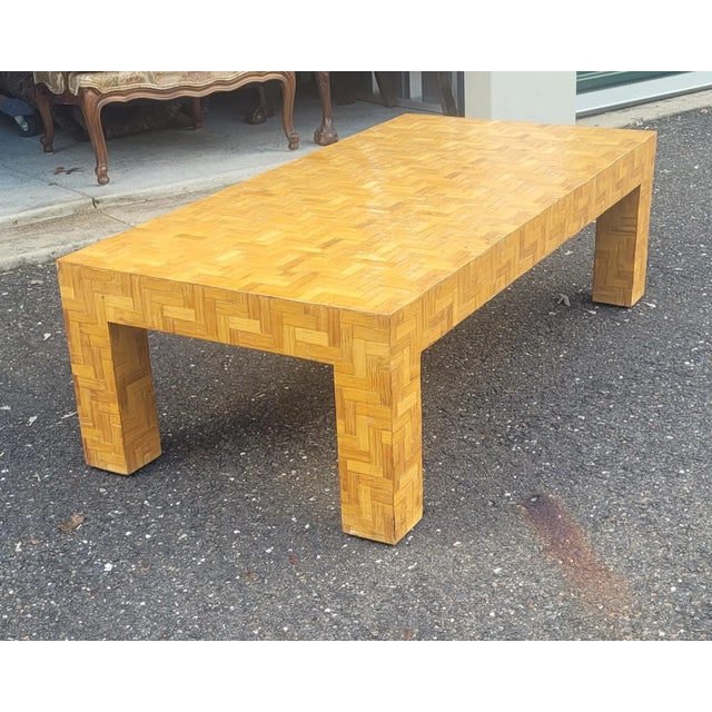 Vintage coffee table in the Palm Beach style. Featuring a herringbone interlaced network of bamboo and rattan all over...