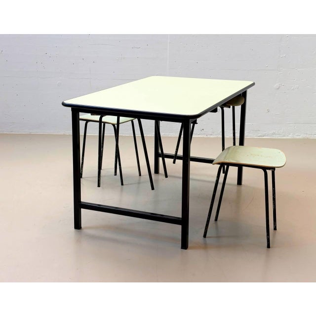 Charming swiss-made dining set from the 1960s, consisting of a rectangular dining table with a classic light green kelko...