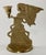 Vintage detailed brass angel figure with robes and hair blowing in the wind. Angel holds a single candlestick. Patina.