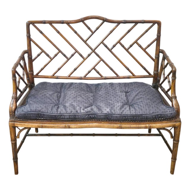 Stylish carved faux bamboo bench crafted in the Chinese Chippendale taste. The bench features hand-carved faux bamboo...