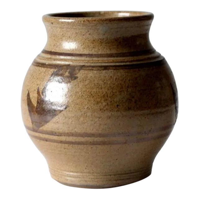 A vintage studio pottery vase, hand-crafted in ceramic with a richly speckled brown glaze and expressive painted accents....