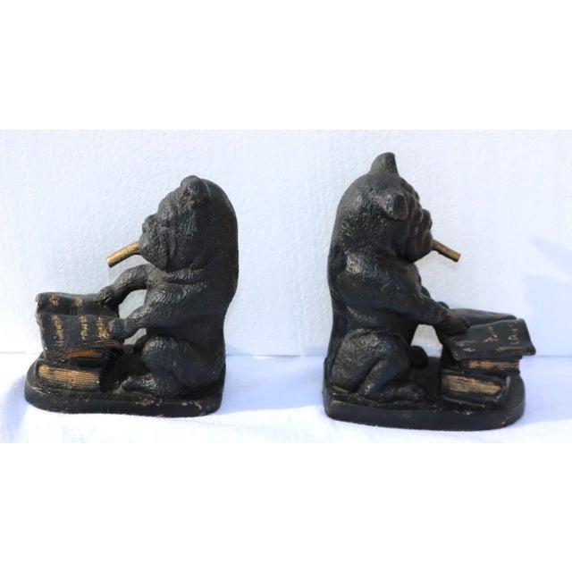 A set of vintage English Bulldog smoking cigars bookends. Made of metal and painted, these bookends are decorated with a...