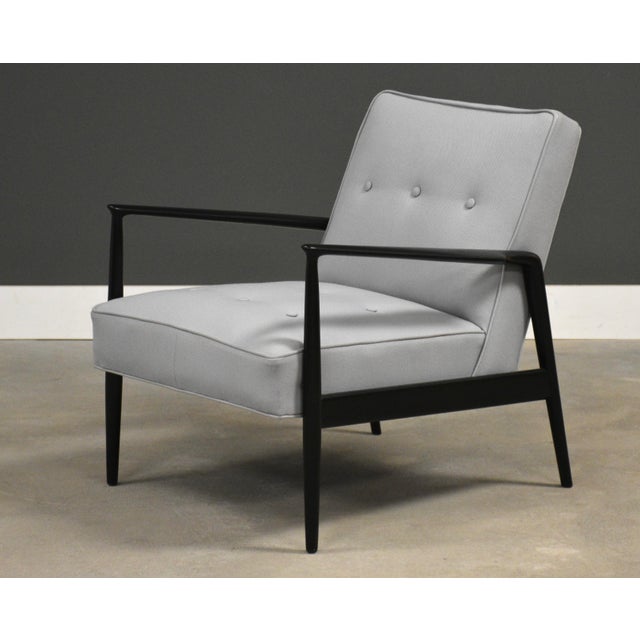 This 1950's ebonized teak lounge chair has wonderful mid century modern lines and has been reupholstered in gray fabric....
