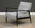 This 1950's ebonized teak lounge chair has wonderful mid century modern lines and has been reupholstered in gray fabric....
