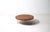 A quietly architectural design by Kho Liang Ie for Artifort. Generous round top in teak veneer with a solid edge, set on...