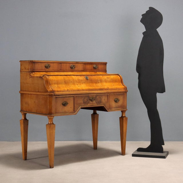 Walnut desk. Central drop-down door, slightly extendable, concealing an internal storage compartment consisting of a...