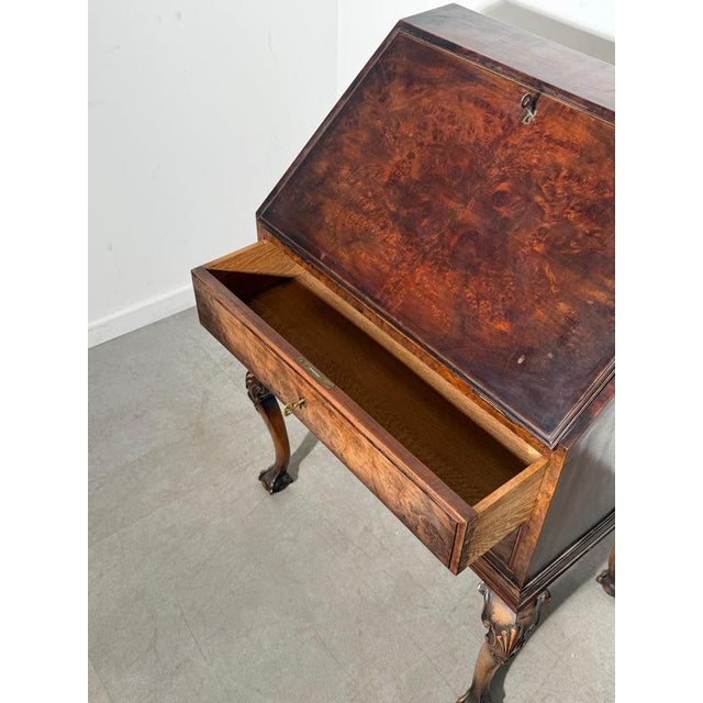 Elegant antique Chippendale secretaire finished in rich burlwood veneer. A refined and characterful piece that brings...